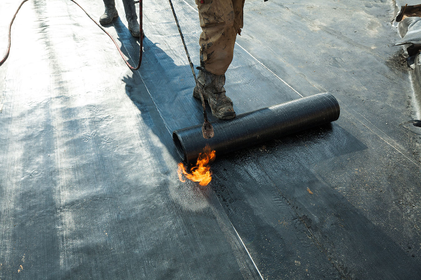 Installation of roll roofing waterproofing propane blowtorch dur